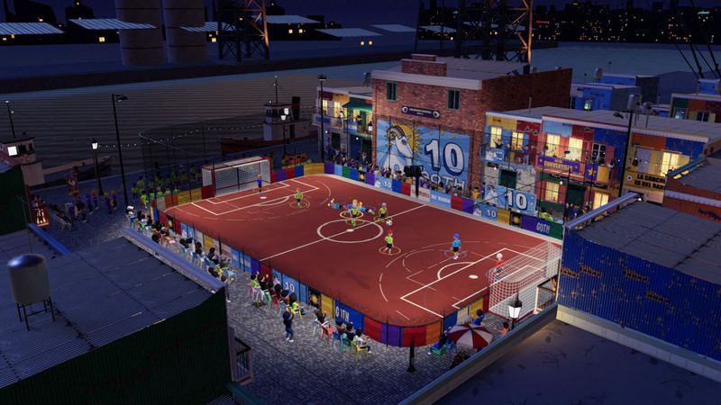 A floodlit red pitch by the harbour at night, among corrugated houses painted in blocks of colour, a goat and a number 10 on the wall behind the goal.
